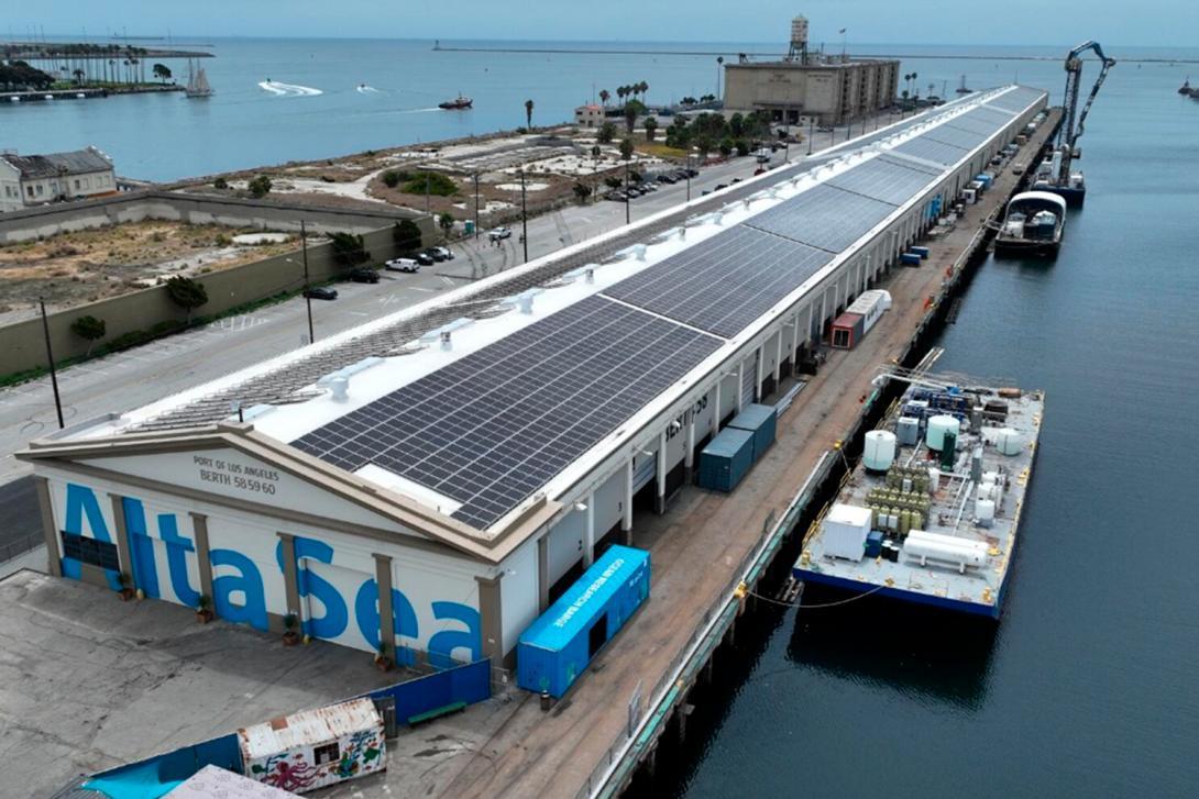 Aerial view of the AltaSea campus at the Port of Los Angeles, with solar panels covering the roofs of its waterside port warehouses.