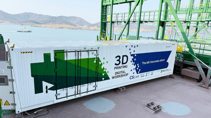 The 3D Printing Digital Workshop system being installed on a Hyundai Merchant Marine cargo ship (HD HYUNDAI HEAVY INDUSTRIES).