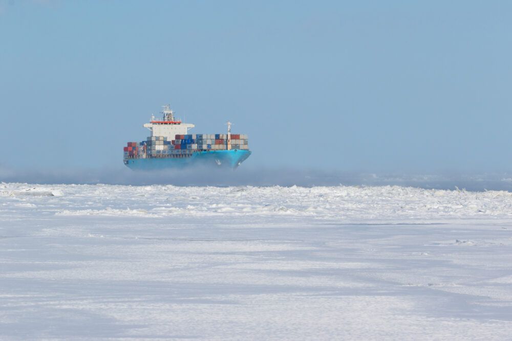 Container ship navigating through Arctic waters amid ice floes, a scene that will become increasingly common (iStock).